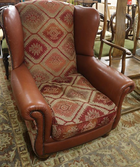 A leather and tapestry upholstered armchair